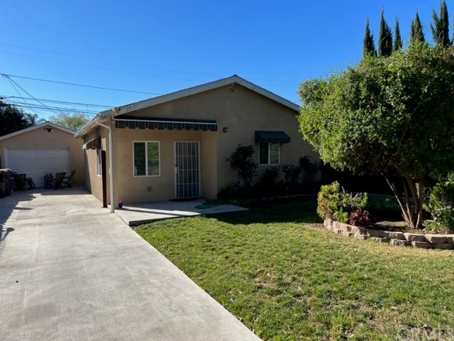 5611 Lemon Avenue Long Beach, CA 90805 - Photo 1 of 1 a view of a house with backyard and trees