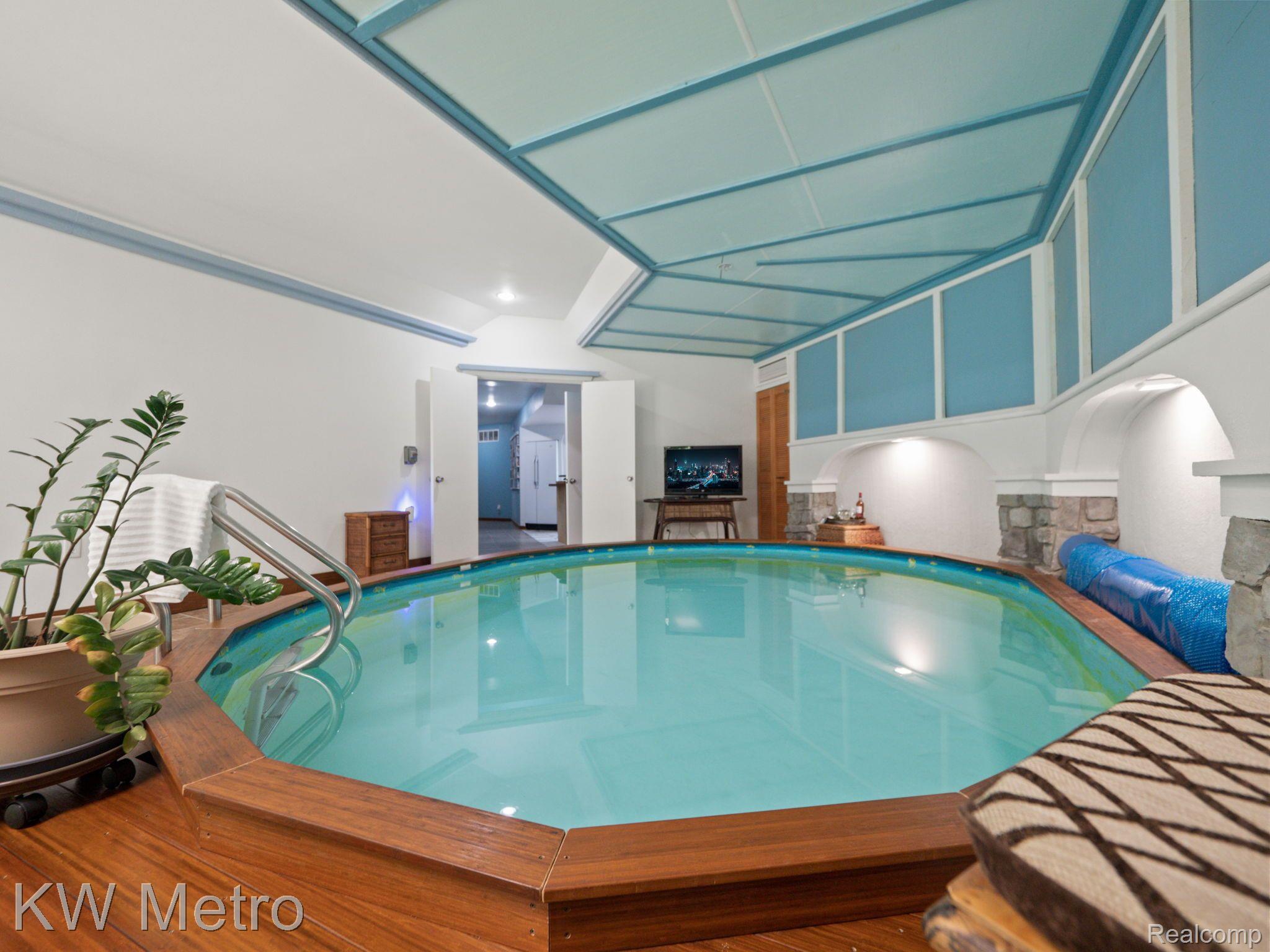 3205 Stanton Road Lake Orion, MI 48362 - Photo 51 of 60 Indoor heated pool with gas fireplace on pool deck
