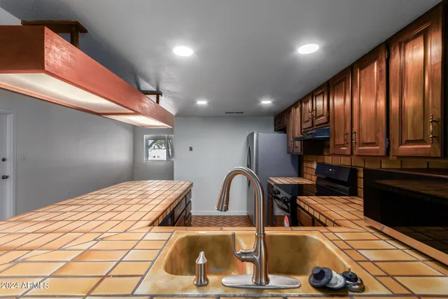 a kitchen with a table chairs and refrigerator