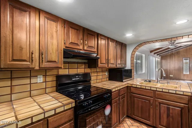 a kitchen with a sink and a refrigerator