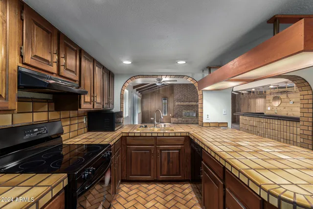 a kitchen with a sink stove and cabinets