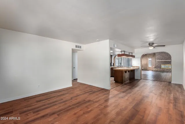 a view of an empty room and wooden floor