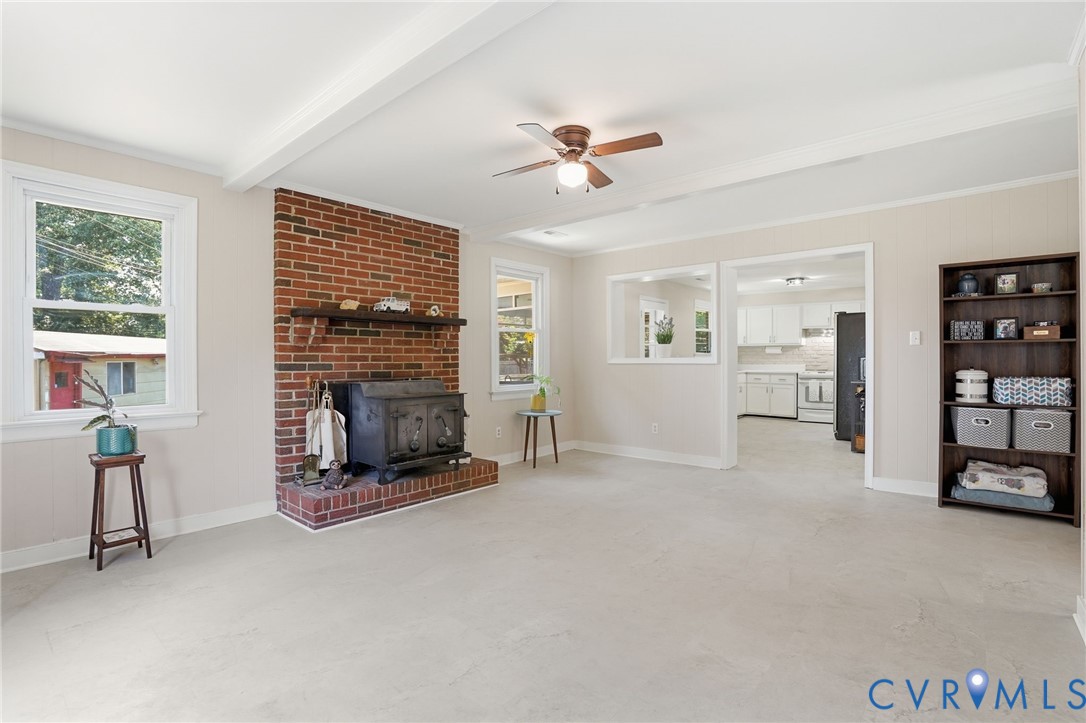 2403 Omega Road Henrico, VA 23228 - Photo 13 of 39 a view of an empty room with a fireplace and a window