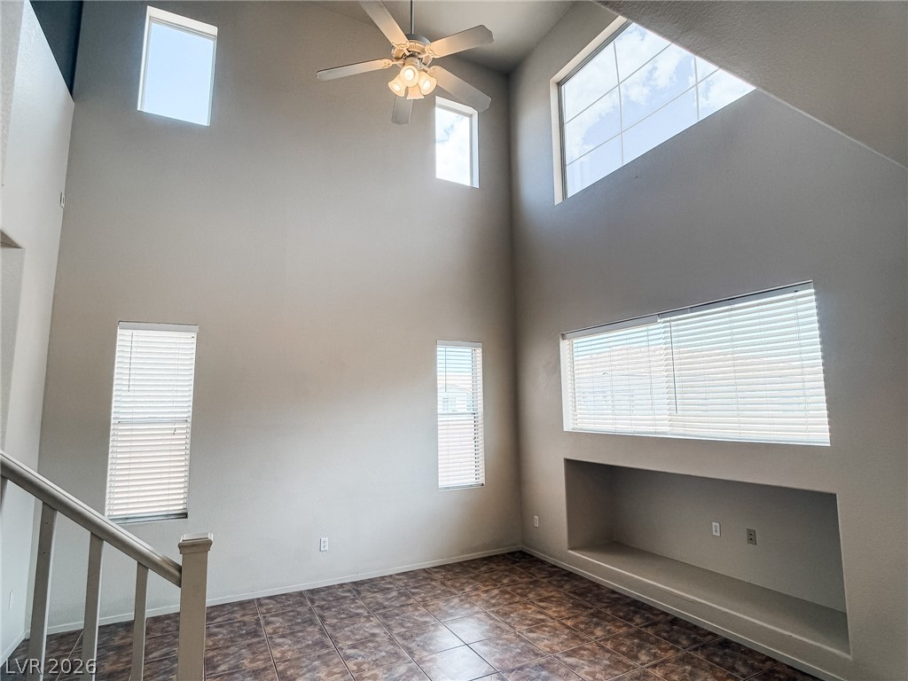 228 Positive Point Street Henderson, NV 89012 - Photo 10 of 27 A well-lit living area boasts high ceilings, a functional built-in niche, and durable tile flooring.