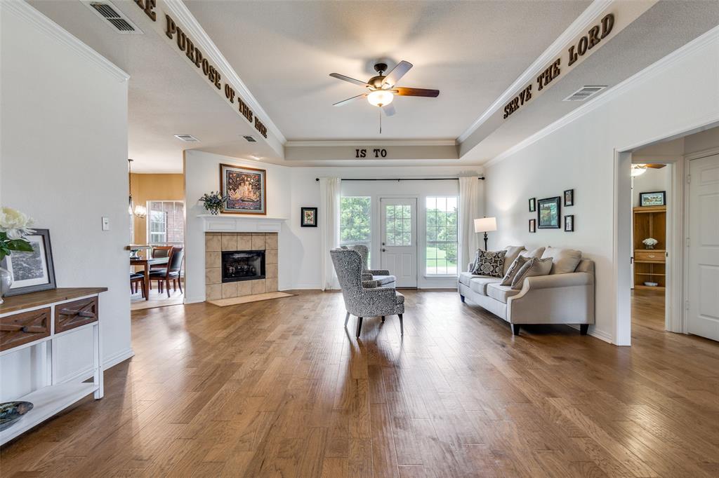 251 Pecan Hollow Circle Anna, TX 75409 - Photo 3 of 12 a living room with fireplace furniture and a wooden floor