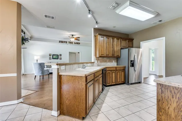 a kitchen with a cabinets and refrigerator