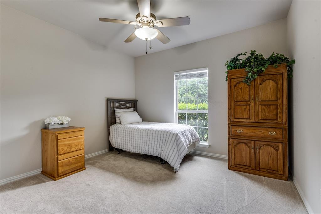 251 Pecan Hollow Circle Anna, TX 75409 - Photo 8 of 12 a bedroom with a bed and a chandelier