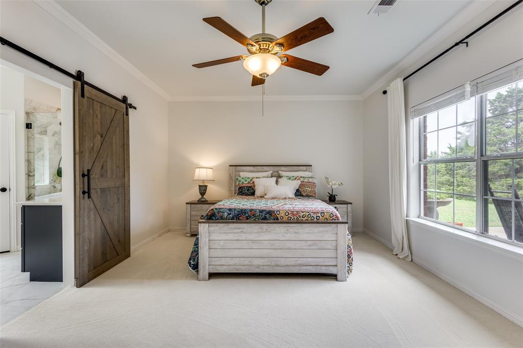 251 Pecan Hollow Circle Anna, TX 75409 - Photo 9 of 12 a bedroom with a bed and a large window