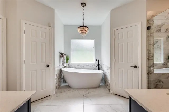 a bathroom with a bathtub and shower