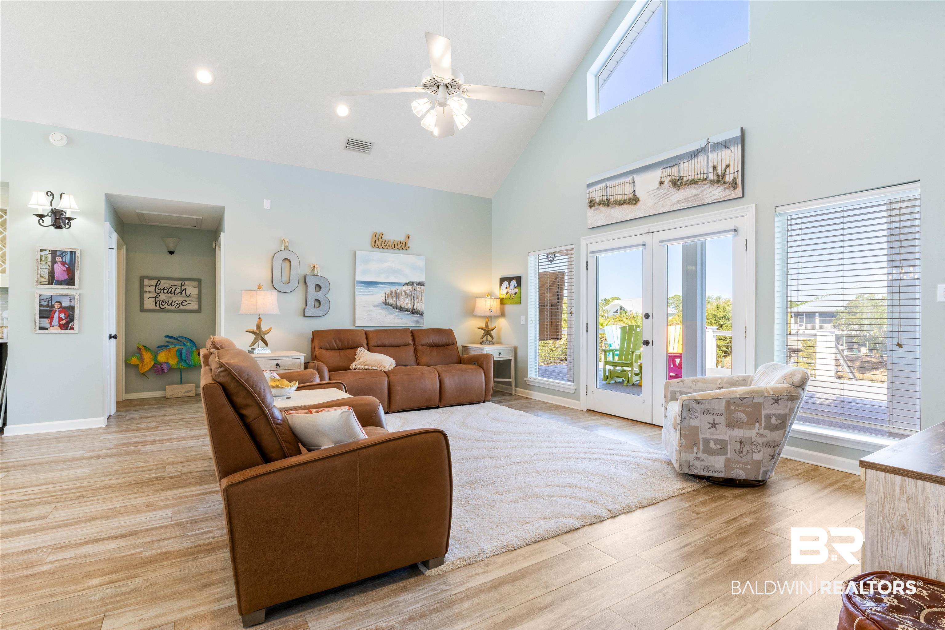 32315 River Road Orange Beach, AL 36561 - Photo 25 of 68 Living area with ceiling fan, french doors, plenty of natural light, light wood like tile flooring, and vaulted ceiling