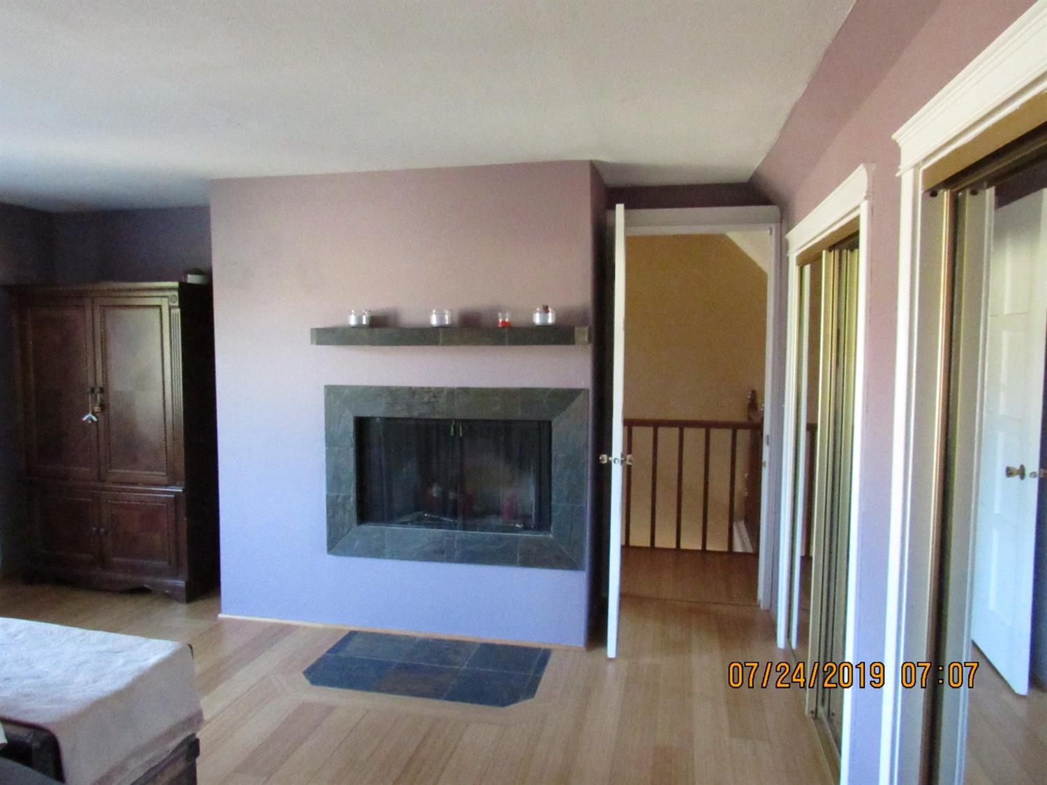 205 Latigo Ranch Road Williams, OR 97544 - Photo 22 of 50 Master bedroom with fireplace