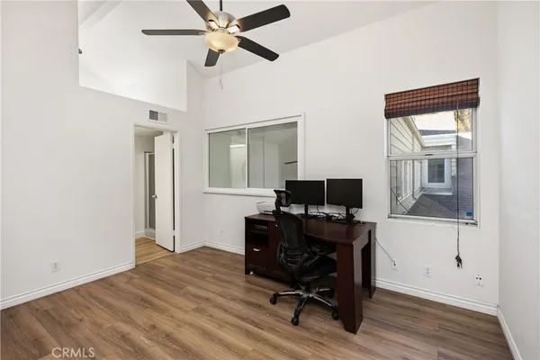 a view of a workspace with furniture and a window