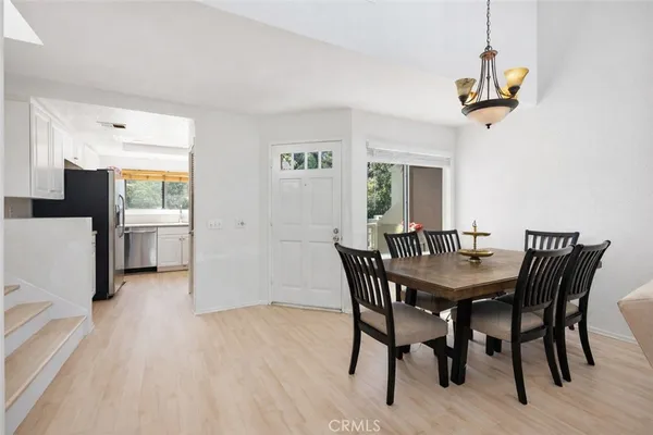 a view of a dining room with furniture and a chandelier