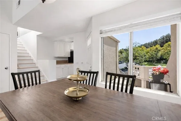 a view of a dining room with furniture window and wooden floor