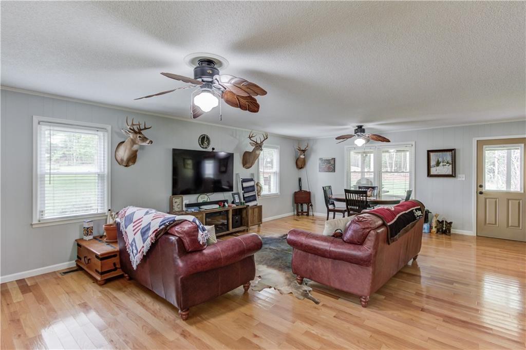 207 Boogers Hill Road Oxford, GA 30054 - Photo 12 of 39 a living room with furniture a flat screen tv and a window