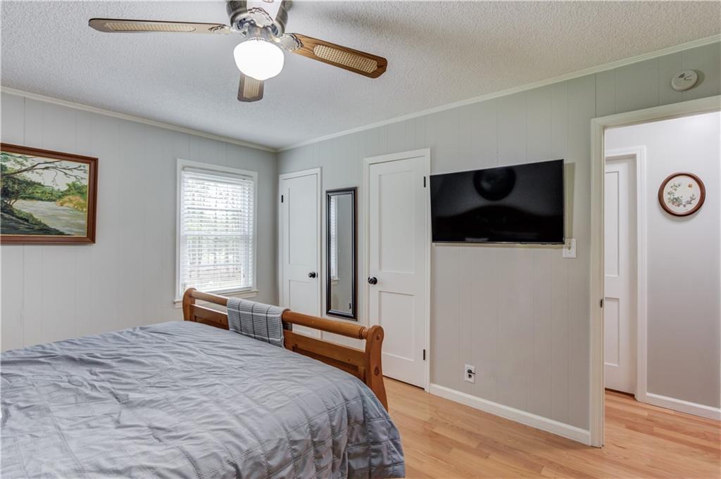 207 Boogers Hill Road Oxford, GA 30054 - Photo 19 of 39 a bedroom with a bed and a chandelier