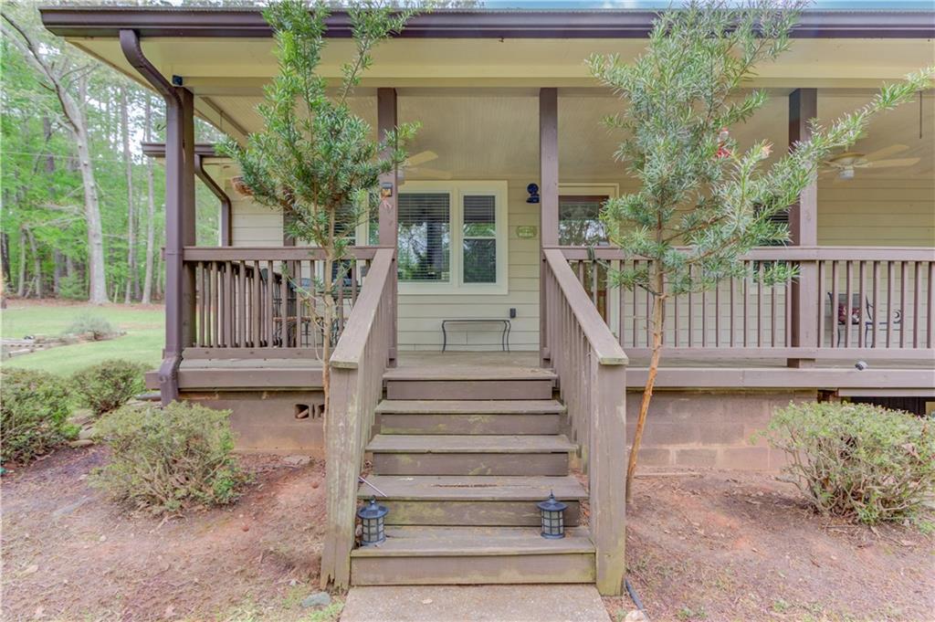 207 Boogers Hill Road Oxford, GA 30054 - Photo 2 of 39 a view of a house with wooden fence next to a yard