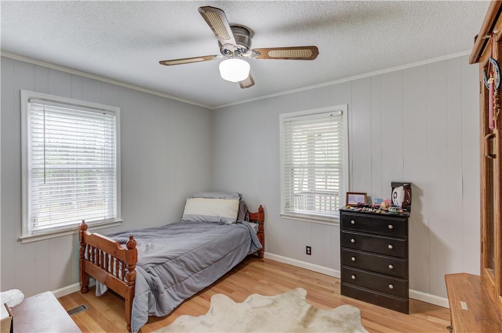207 Boogers Hill Road Oxford, GA 30054 - Photo 21 of 39 a bedroom with a bed and a dresser