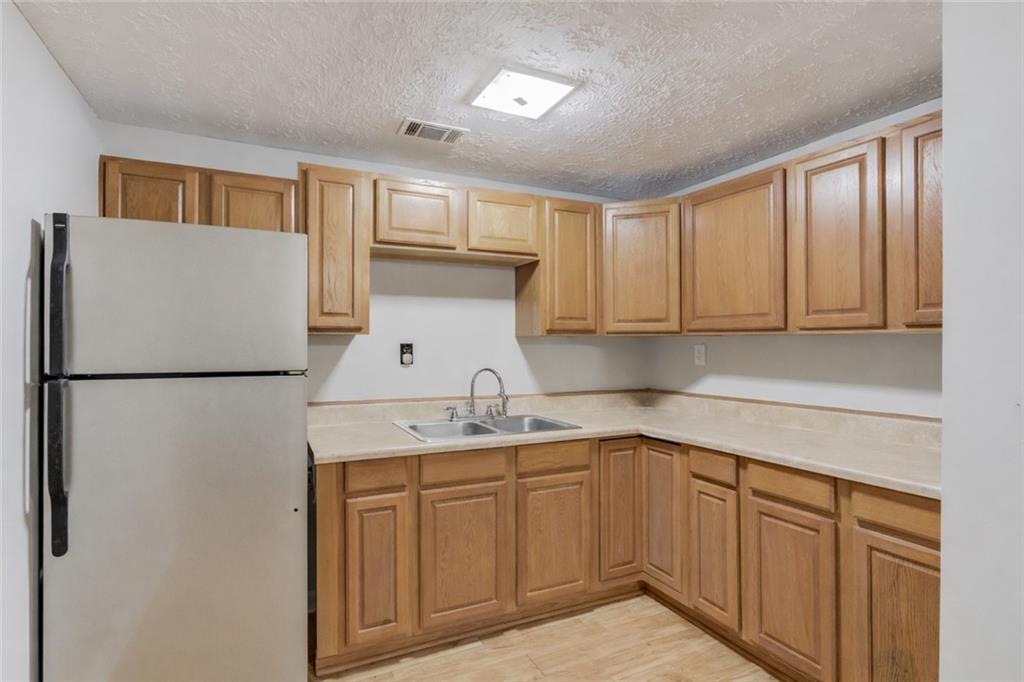 207 Boogers Hill Road Oxford, GA 30054 - Photo 24 of 39 a kitchen with a sink refrigerator and cabinets