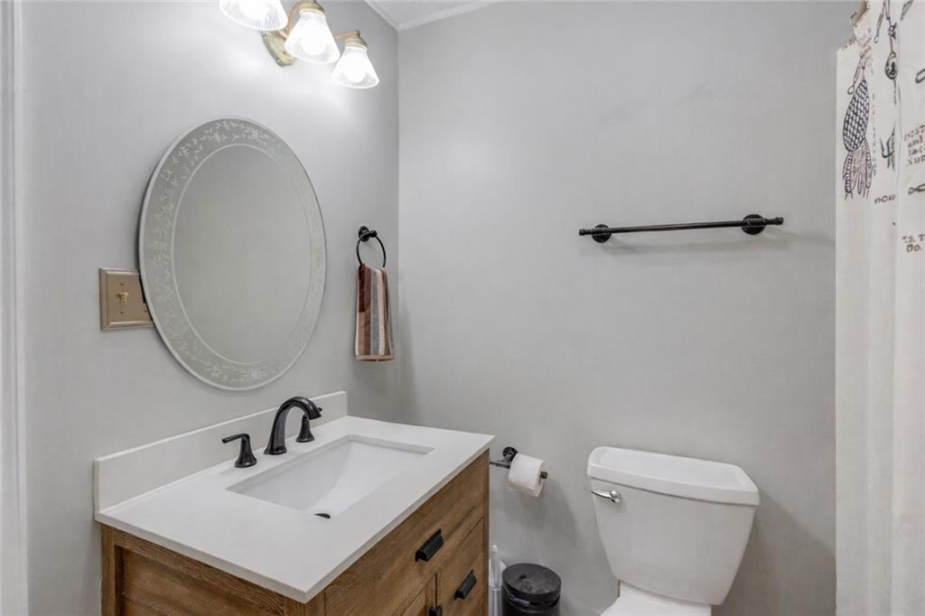 207 Boogers Hill Road Oxford, GA 30054 - Photo 27 of 39 a bathroom with a toilet sink and mirror