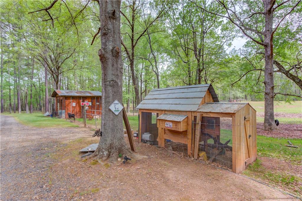 207 Boogers Hill Road Oxford, GA 30054 - Photo 34 of 39 a wooden house with large trees and outdoor space