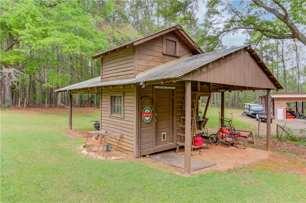207 Boogers Hill Road Oxford, GA 30054 - Photo 35 of 39 a view of a house with a patio chairs and a yard