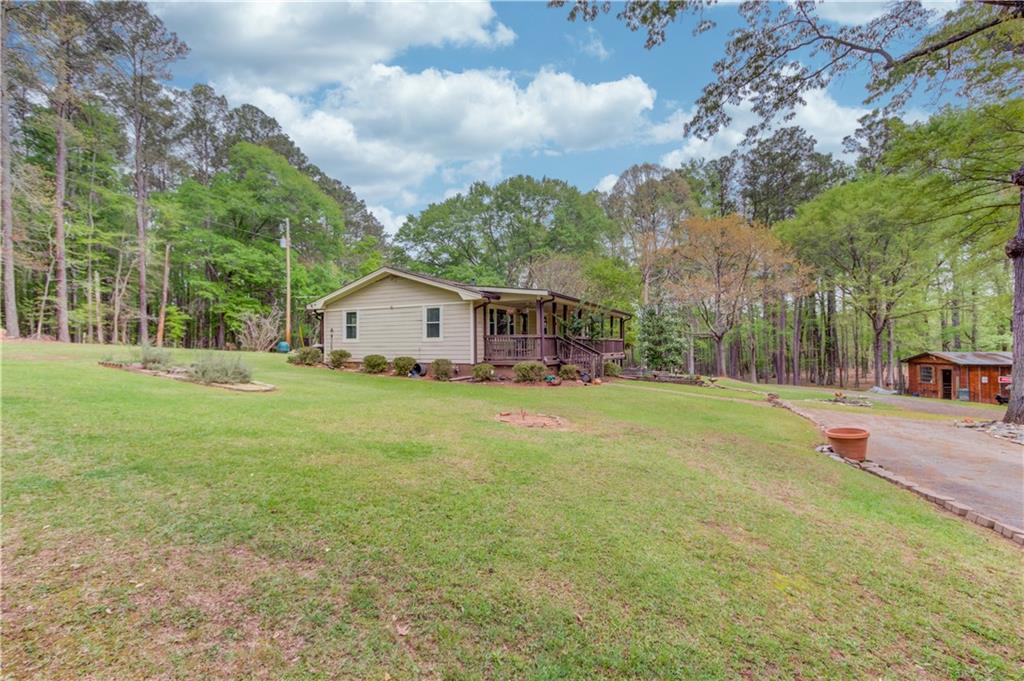 207 Boogers Hill Road Oxford, GA 30054 - Photo 5 of 39 a house view with swimming pool in front of it