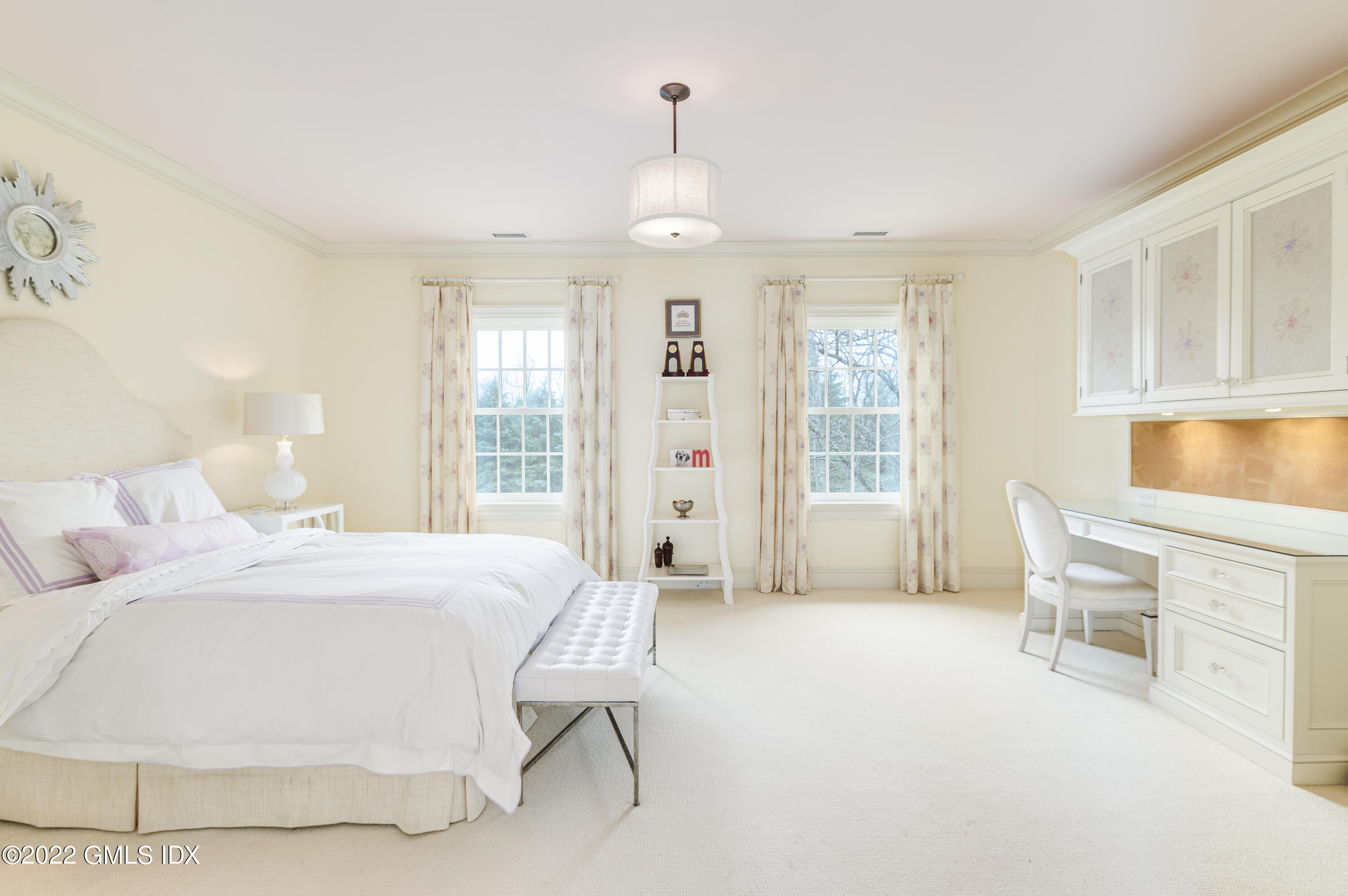 149 Parsonage Road Greenwich, CT 06830 - Photo 22 of 35 a spacious bedroom with a bed and glass window