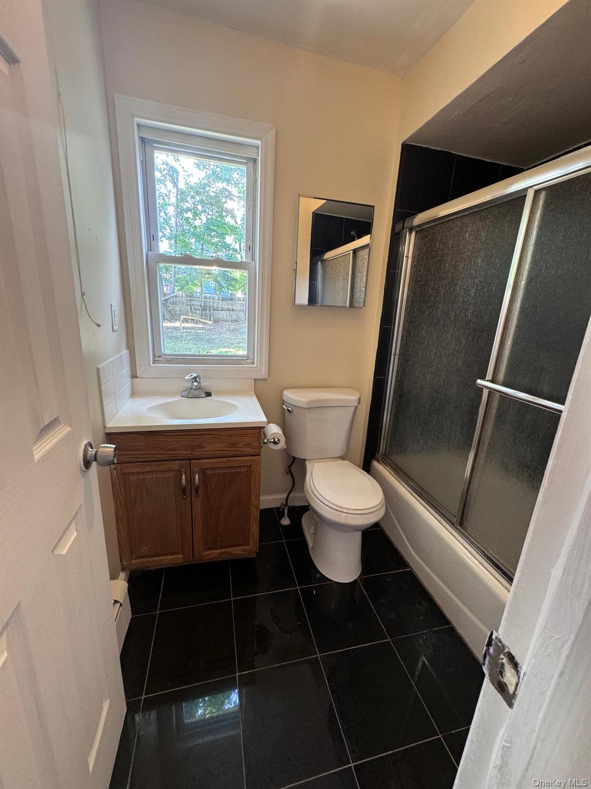 77 Cottage Street, Unit 1 Poughkeepsie, NY 12601 - Photo 11 of 13 a bathroom with a toilet a sink and a shower