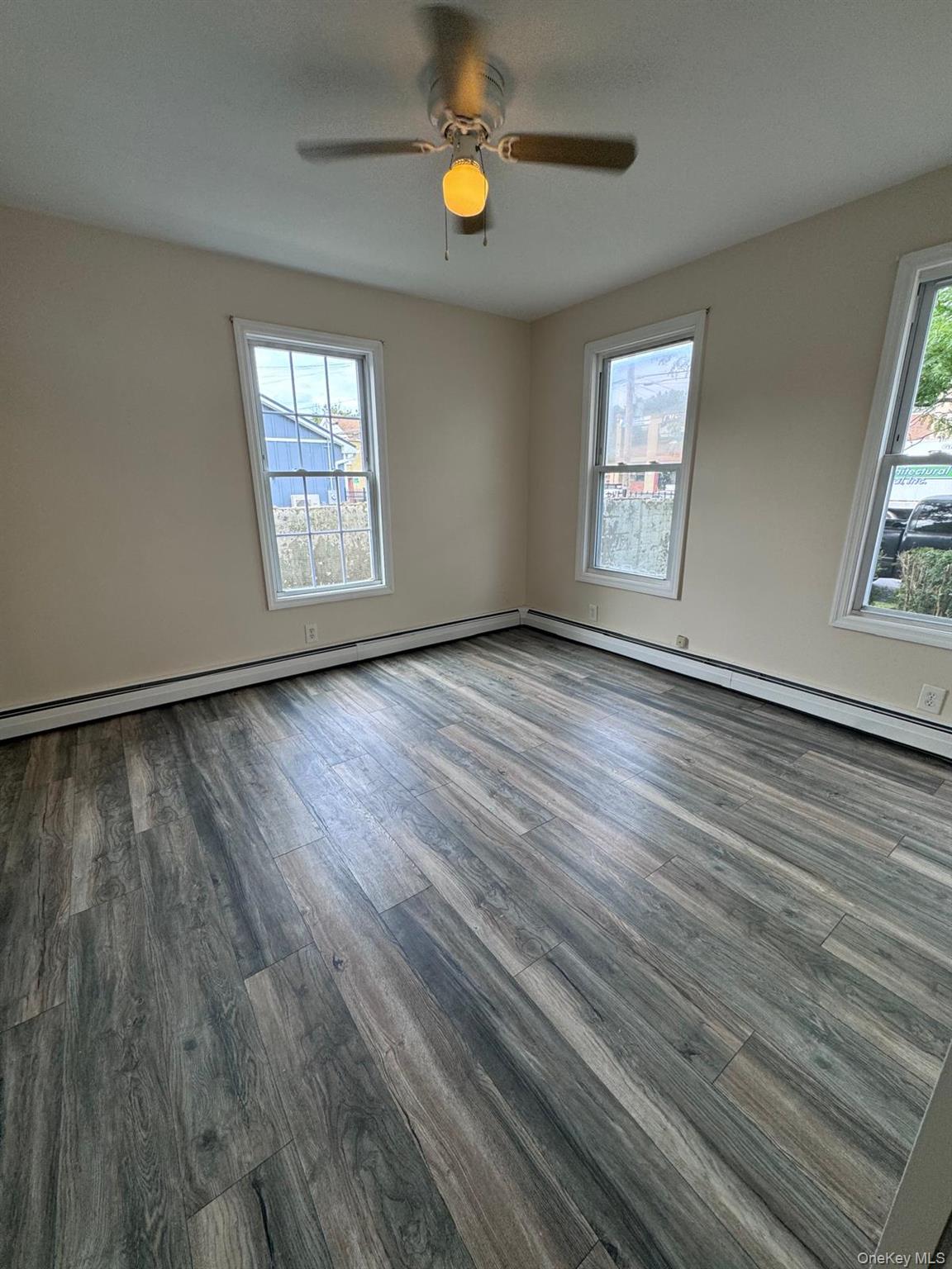 77 Cottage Street, Unit 1 Poughkeepsie, NY 12601 - Photo 4 of 13 wooden floor in an empty room with a window