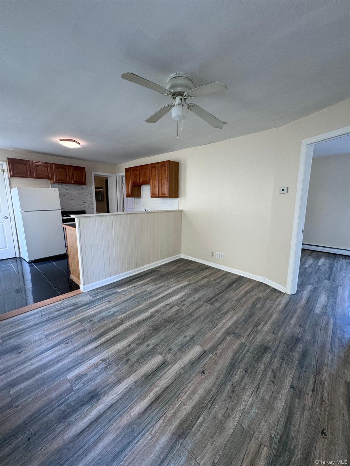 77 Cottage Street, Unit 1 Poughkeepsie, NY 12601 - Photo 6 of 13 a view of a livingroom with wooden floor and a ceiling fan