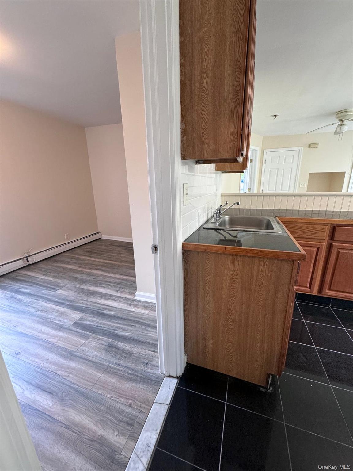 77 Cottage Street, Unit 1 Poughkeepsie, NY 12601 - Photo 8 of 13 a kitchen with granite countertop a sink and a stove top oven
