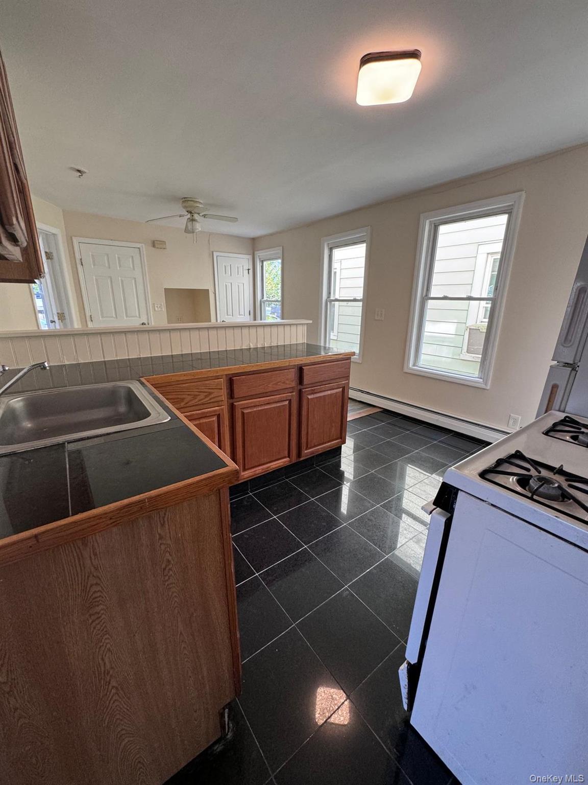 77 Cottage Street, Unit 1 Poughkeepsie, NY 12601 - Photo 10 of 13 a room with lots of appliances and windows