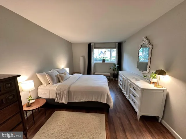 a bed room with a bed window and a chair