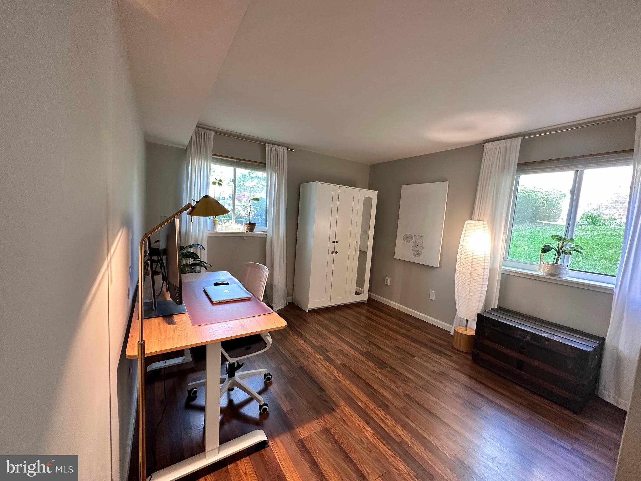 1661 Parkcrest Circle, Unit 100 Reston, VA 20190 - Photo 10 of 13 a view of a room with wooden floor and window