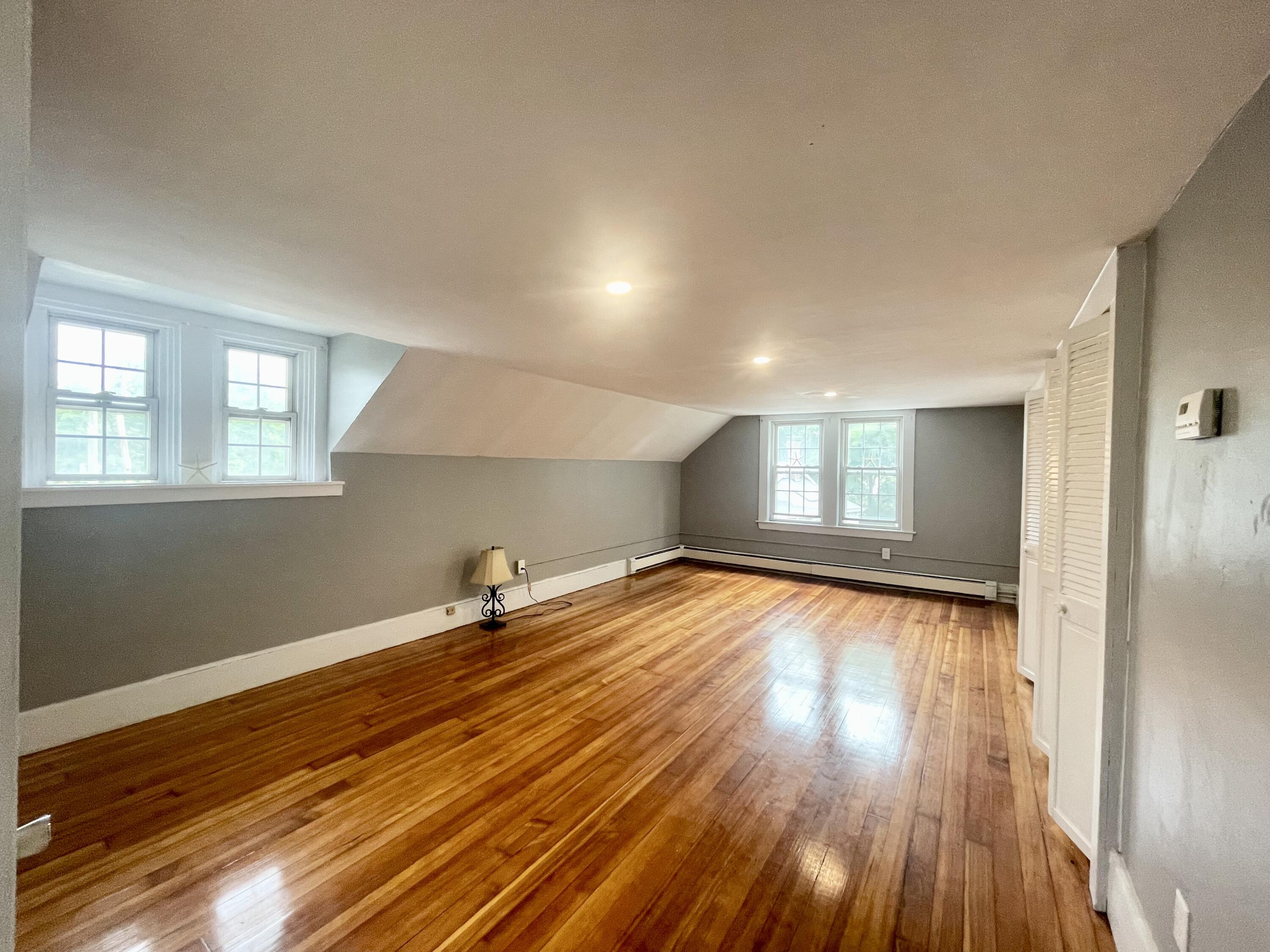 740 Sandwich Road Bourne, MA 02532 - Photo 32 of 50 a view of empty room with wooden floor and fan
