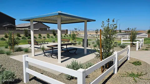 a view of a chair and tables in the patio