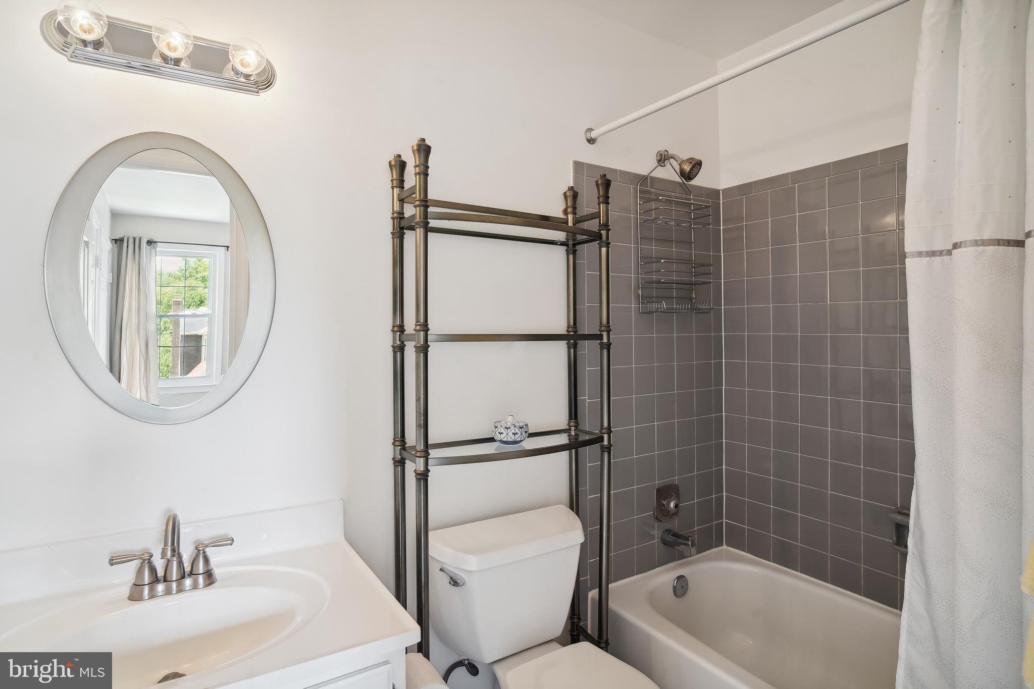 1049 Windrush Lane, Unit 2 Sandy Spring, MD 20860 - Photo 22 of 59 a bathroom with a toilet sink and shower