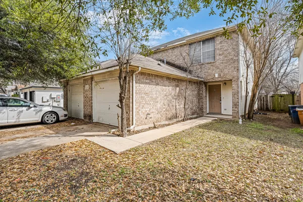 a view of a house with a yard and garage
