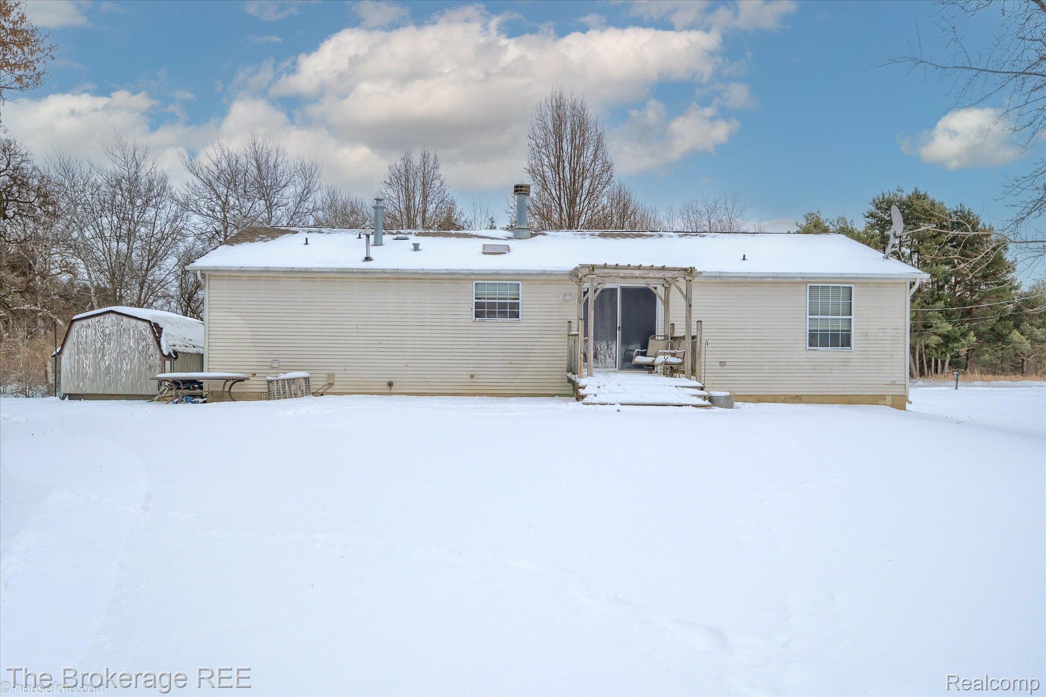 8247 North Center Road Mount Morris, MI 48458 - Photo 3 of 46 Snow covered rear of property with an outdoor structure
