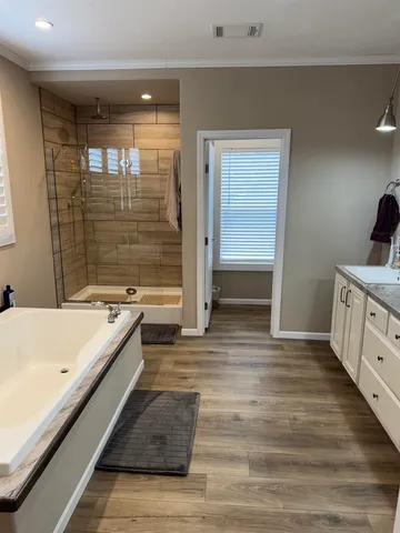 a spacious bathroom with a double vanity sink and a mirror