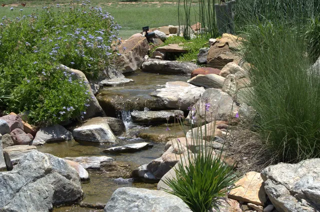 a view of a lake with lawn chairs