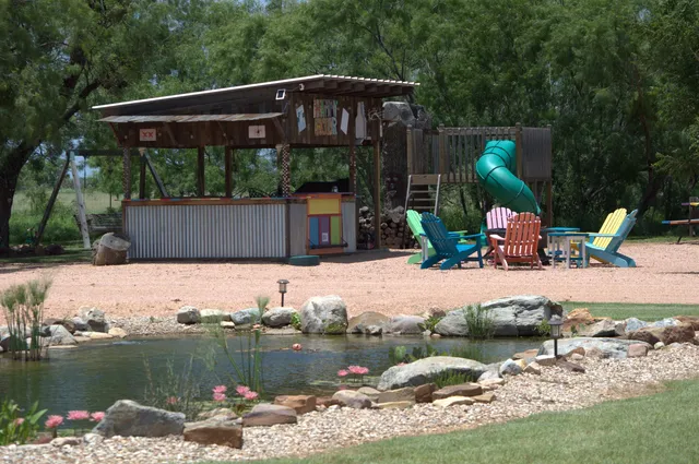 a front view of a house with a yard fire pit and outdoor seating