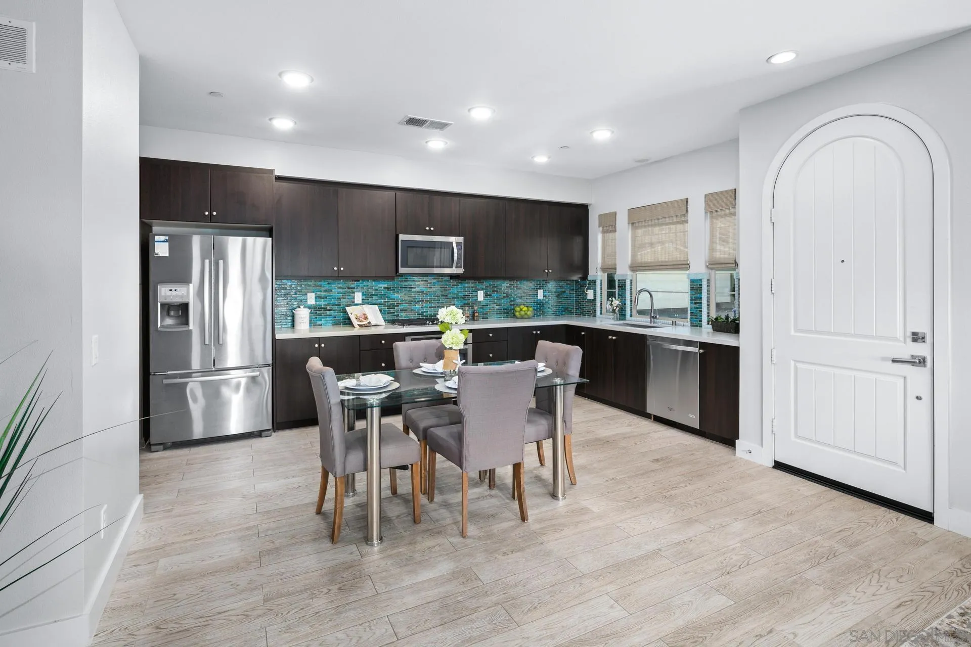 1676 Shorebreak Way Encinitas, CA 92024 - Photo 11 of 62 a dining room with furniture a window and kitchen view