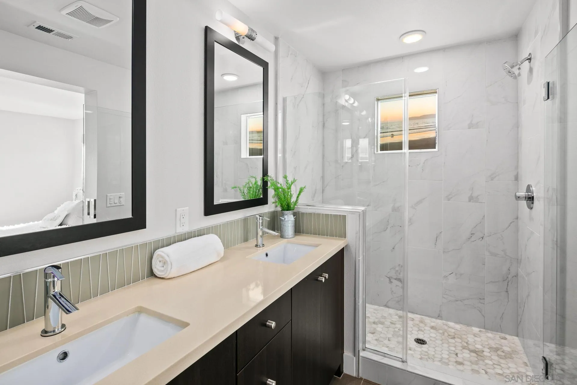 1676 Shorebreak Way Encinitas, CA 92024 - Photo 19 of 62 a bathroom with a double vanity sink mirror and shower