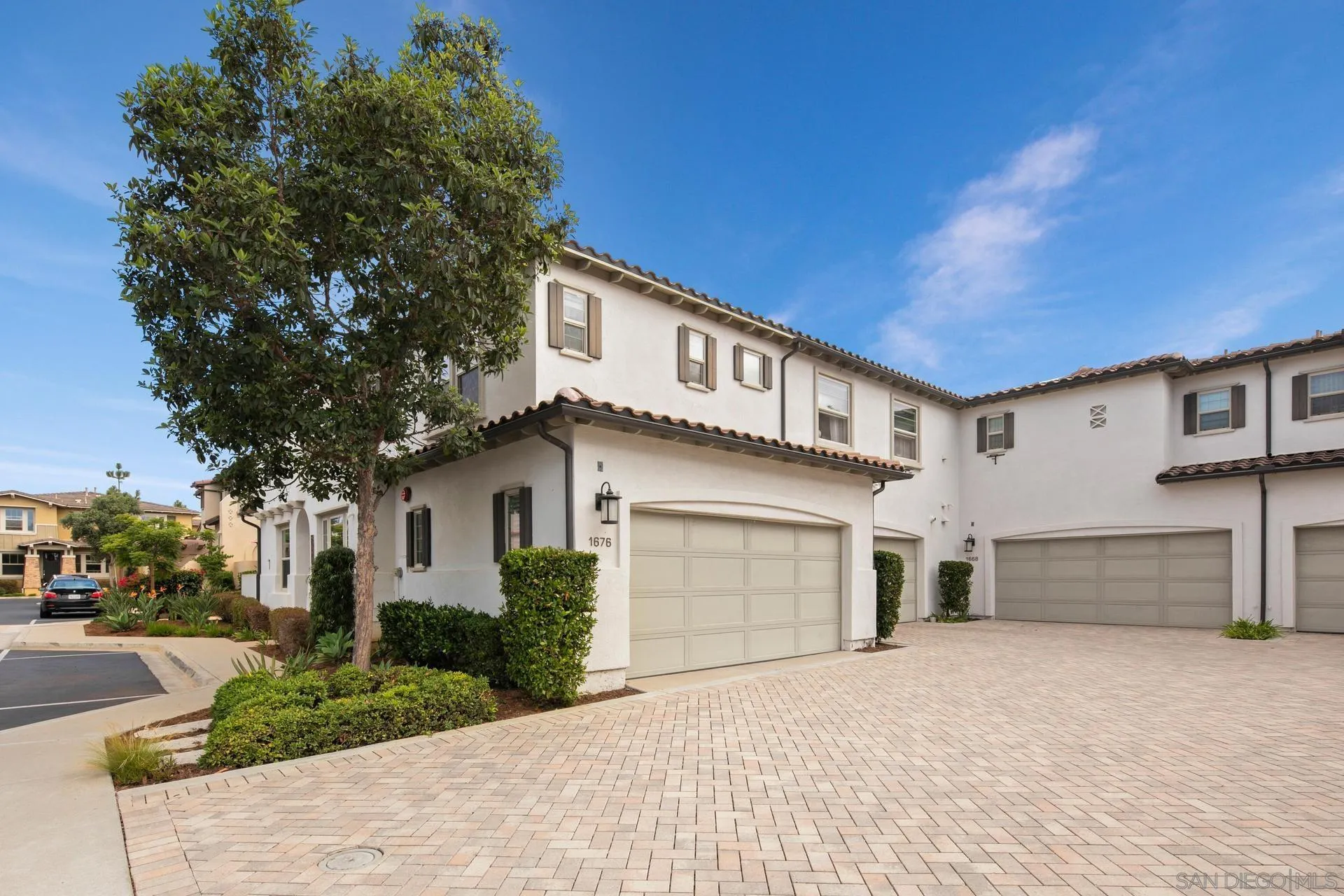 1676 Shorebreak Way Encinitas, CA 92024 - Photo 35 of 62 a front view of a house with a yard and garage