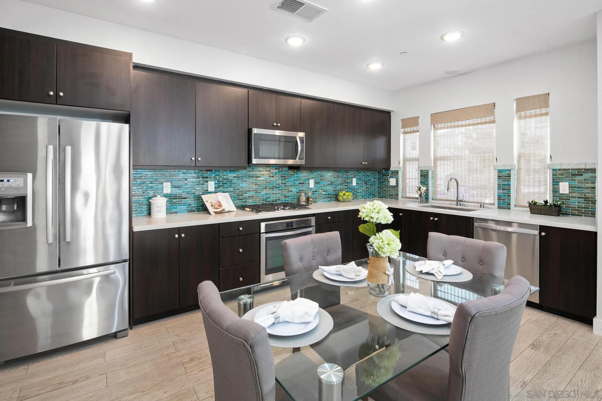 1676 Shorebreak Way Encinitas, CA 92024 - Photo 5 of 62 a dining room with furniture a large window and kitchen view