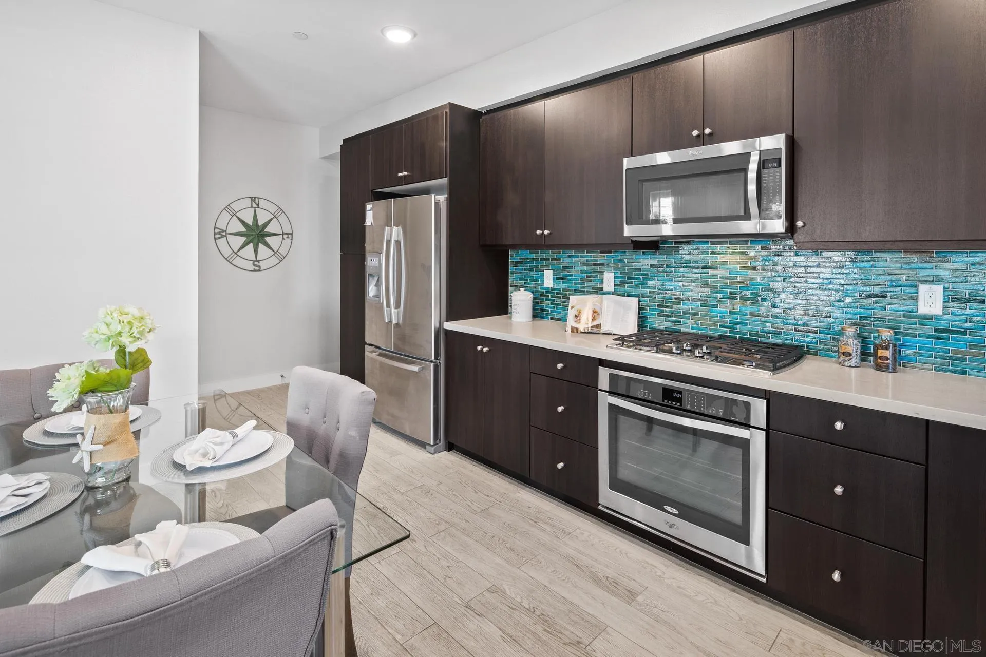 1676 Shorebreak Way Encinitas, CA 92024 - Photo 7 of 62 a kitchen with stainless steel appliances granite countertop a stove a sink dishwasher and cabinets