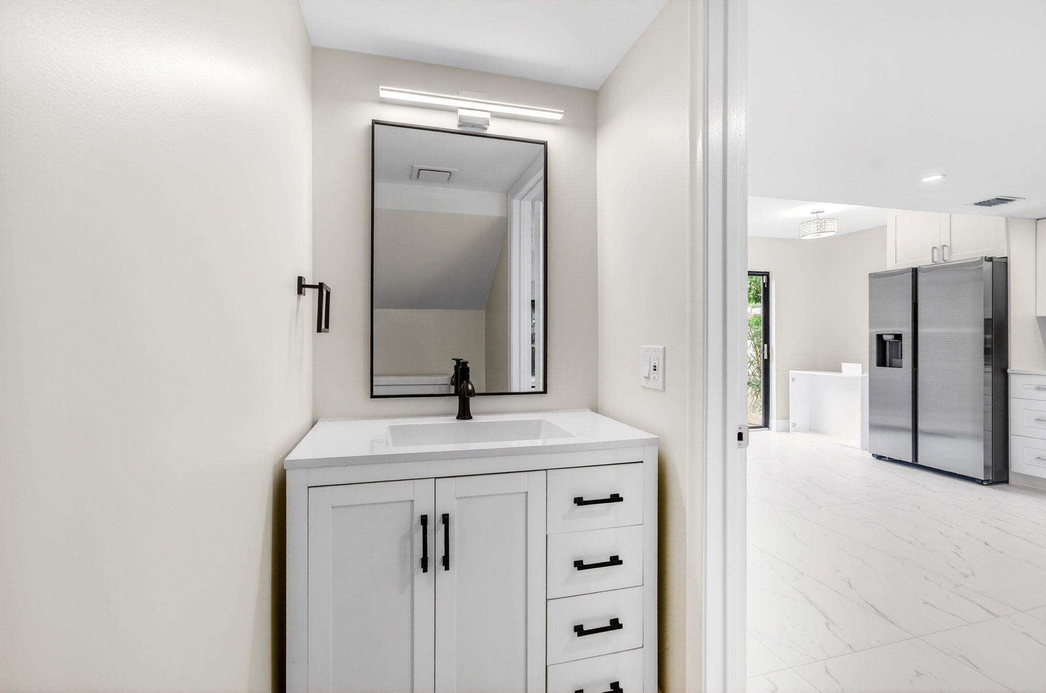 1330 Northwest 13th Street, Unit 12 Boca Raton, FL 33486 - Photo 19 of 52 a bathroom with a sink a vanity and a mirror