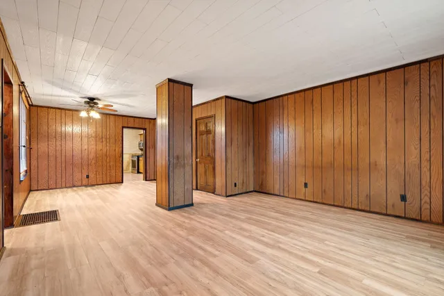 a view of an empty room with wooden floor
